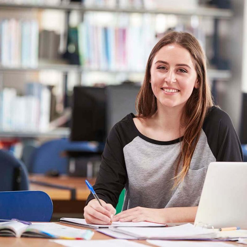 portrait-of-female-student-working-at-laptop-in-co-P5GWU9L-1-1.jpg